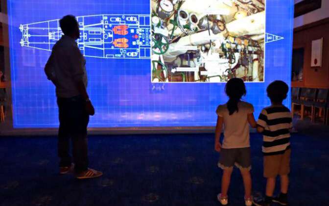 HMS Wellington engine projection with people